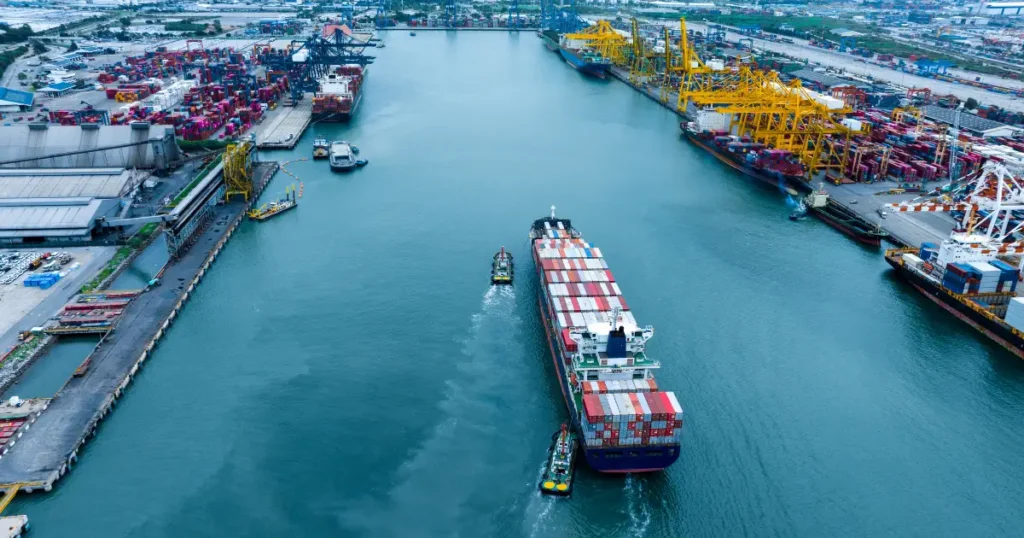 Large ship with shipping containers entering large port