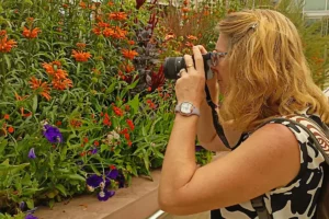 April, cofounder of MicroOffice Solutions taking photos of flowers at Denver Botanical Garden