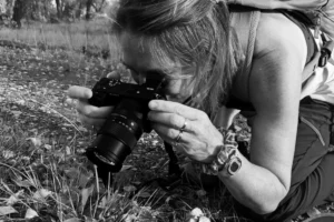 April, cofounder of MicroOffice Solutions , taking photos of a spider in Wyoming
