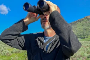 Dave, cofounder of MicroOffice Solutions , checking out Yellowstone Park with binoculars