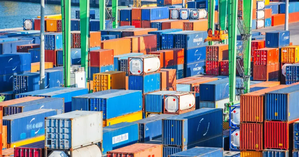 Shipping containers stacked, showing impact of de minimis tariff changes to e-commerce business