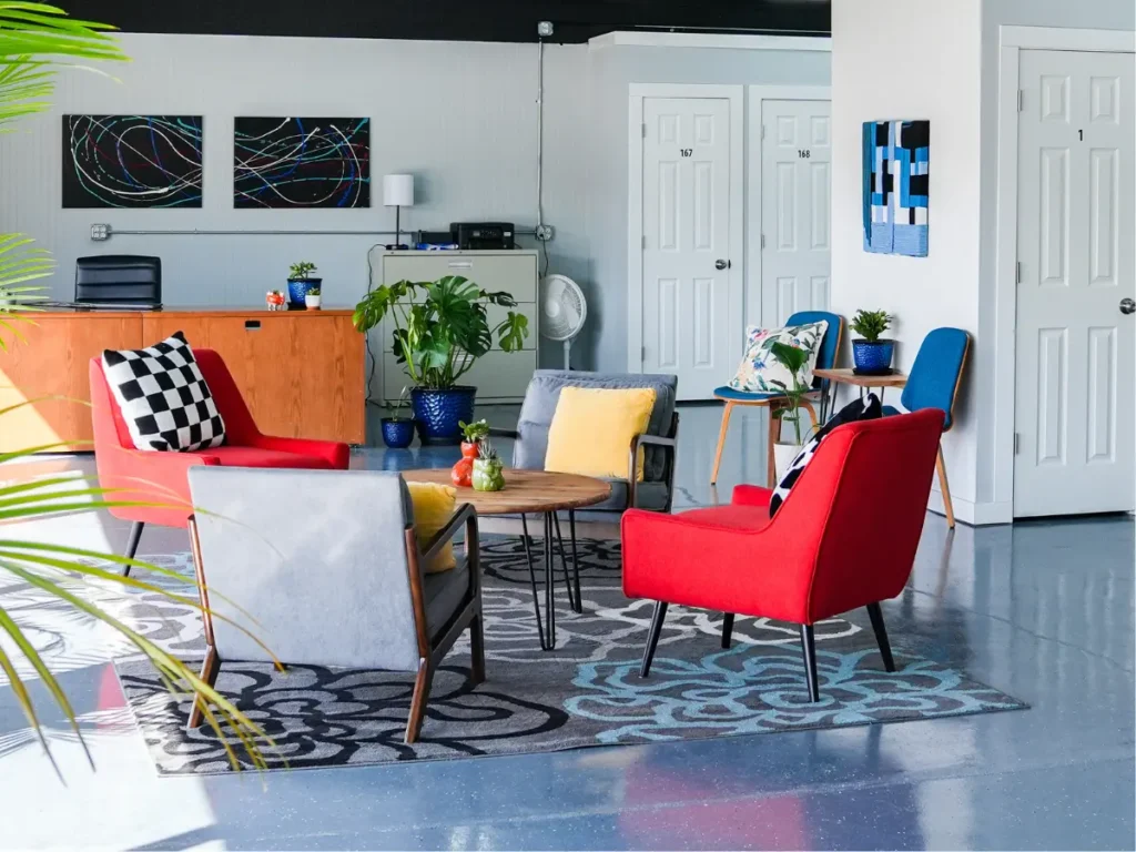 MicroOffice Solutions Casper Wyoming front lobby with reception desk, red and blue seating, plants, abstract artwork and private micro-office suite doors